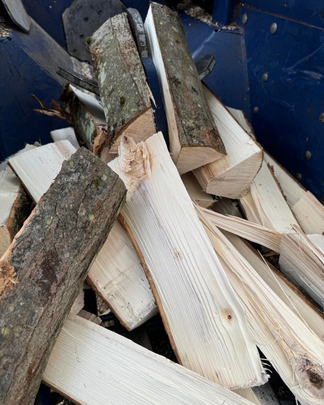A pile of wood is being processed by a machine