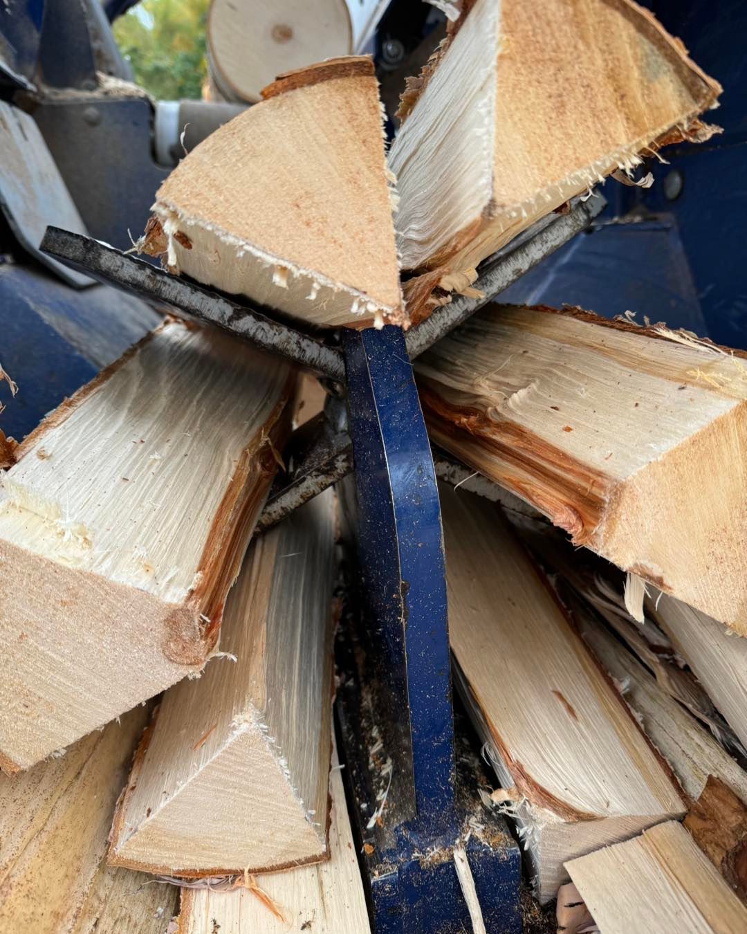 A pile of wood is being processed by a machine.