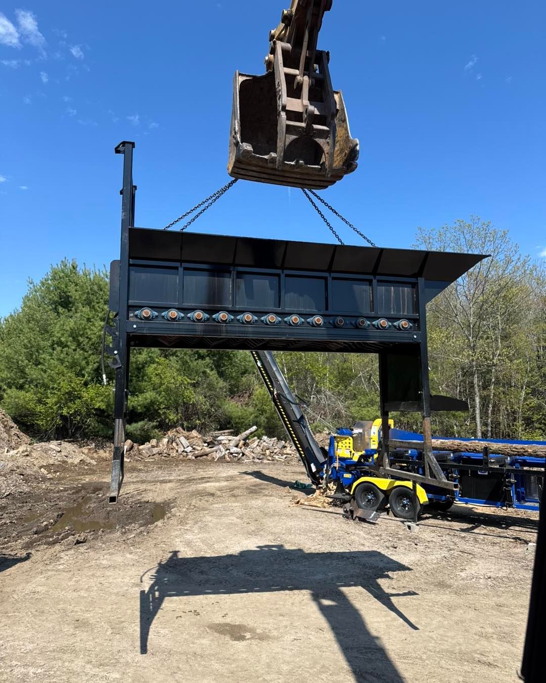 A large piece of metal is being lifted by a crane.