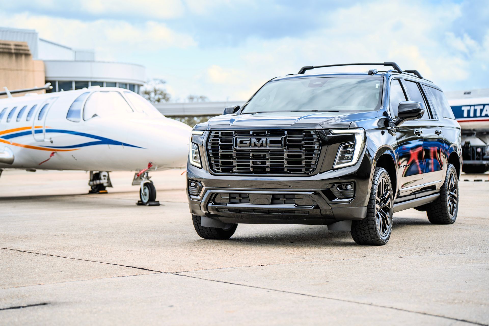 A woman is sitting in the back seat of a car.