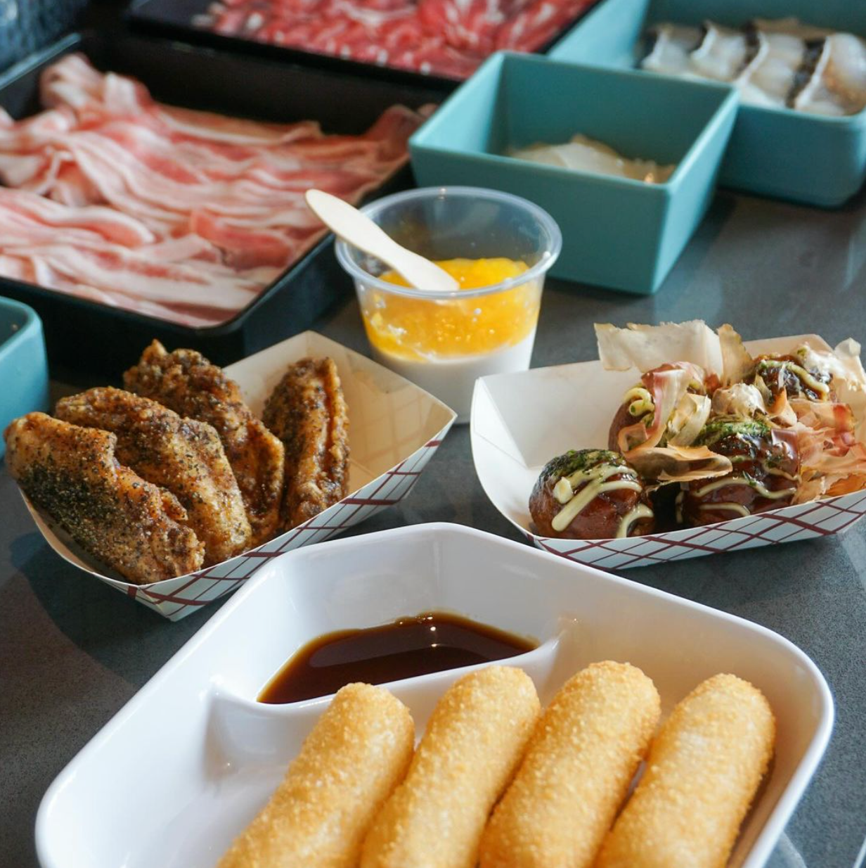 A table topped with a variety of food including french fries