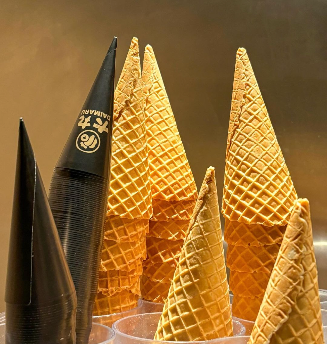 A bunch of ice cream cones are stacked on top of each other