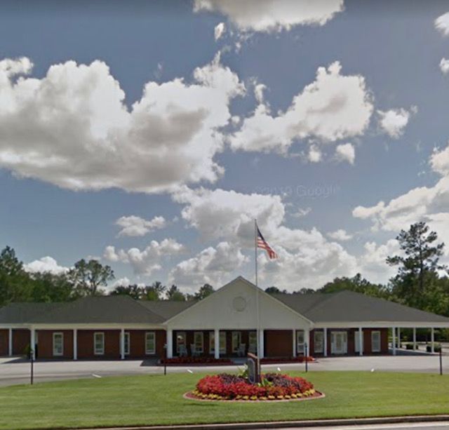 a large building with a flag in front of it
