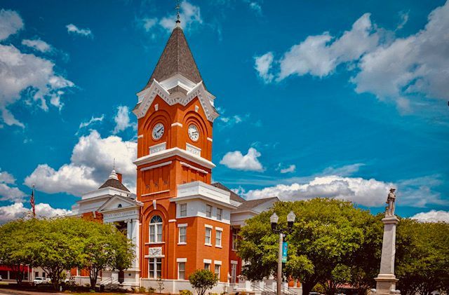 a large red brick building with a clock tower on top of it .