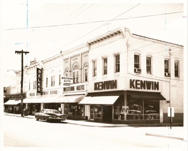 a black and white photo of a row of stores including kenwin