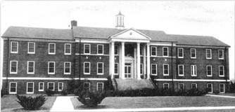 a black and white photo of a large brick building