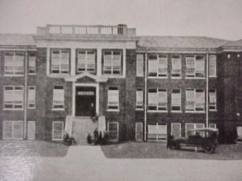a black and white photo of a large brick building