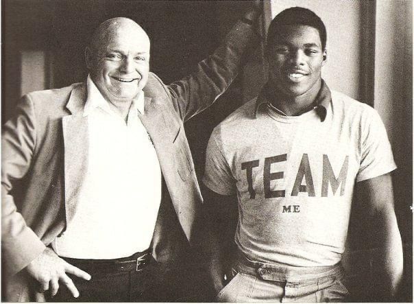 two men are posing for a picture and one of them is wearing a shirt that says team me