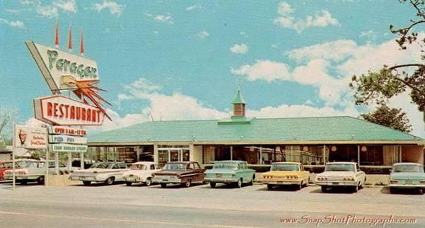 a vintage photo of a restaurant with cars parked in front of it