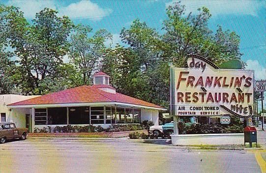 a picture of franklin 's restaurant with a sign in front of it .