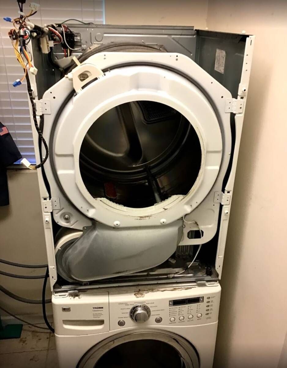a washer and dryer stacked on top of each other with the door open