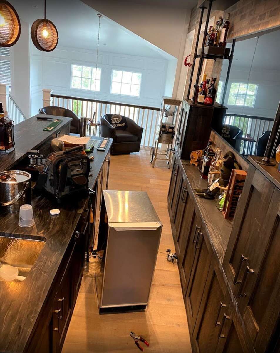 a kitchen with a stainless steel refrigerator on the floor