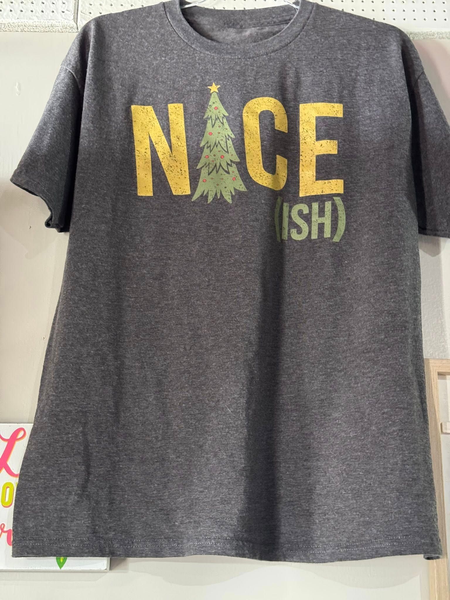 Gray T-shirt with yellow “NICE” text and a tree-shaped letter on the front