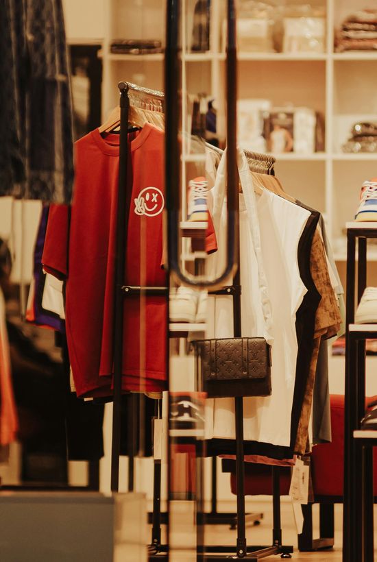 Clothing rack with red, white, and black garments in a retail store