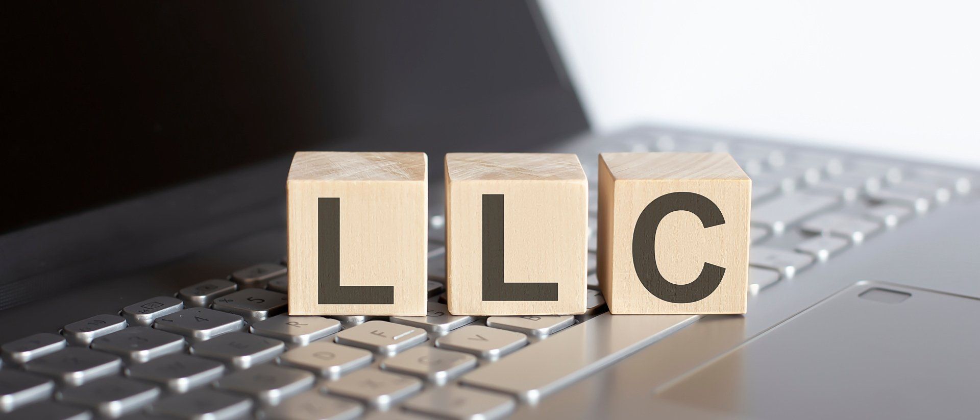 wooden blocks llc on top of laptop keyboard