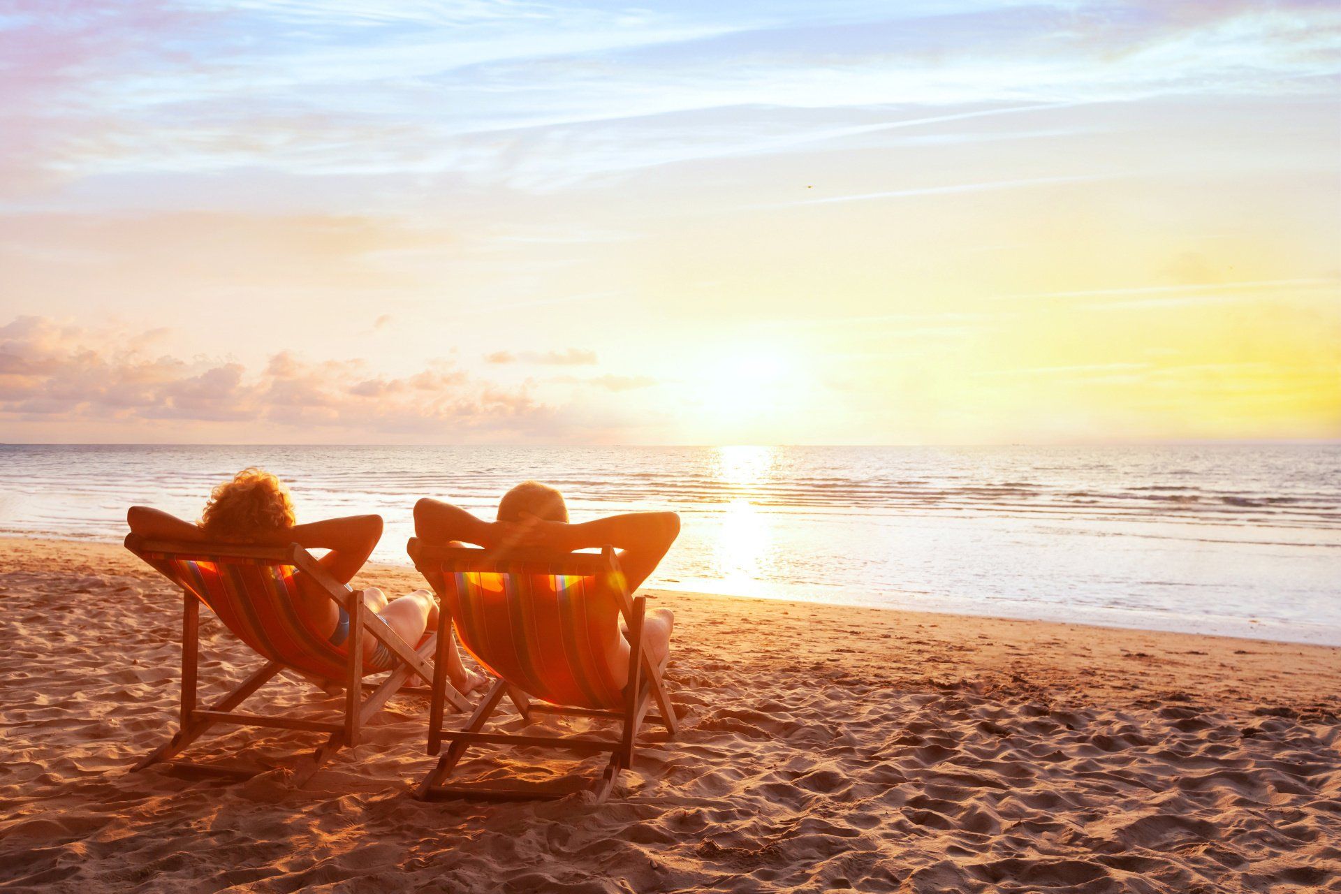 retired people sitting on the beach
