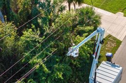 An aerial view of a person working on power lines.