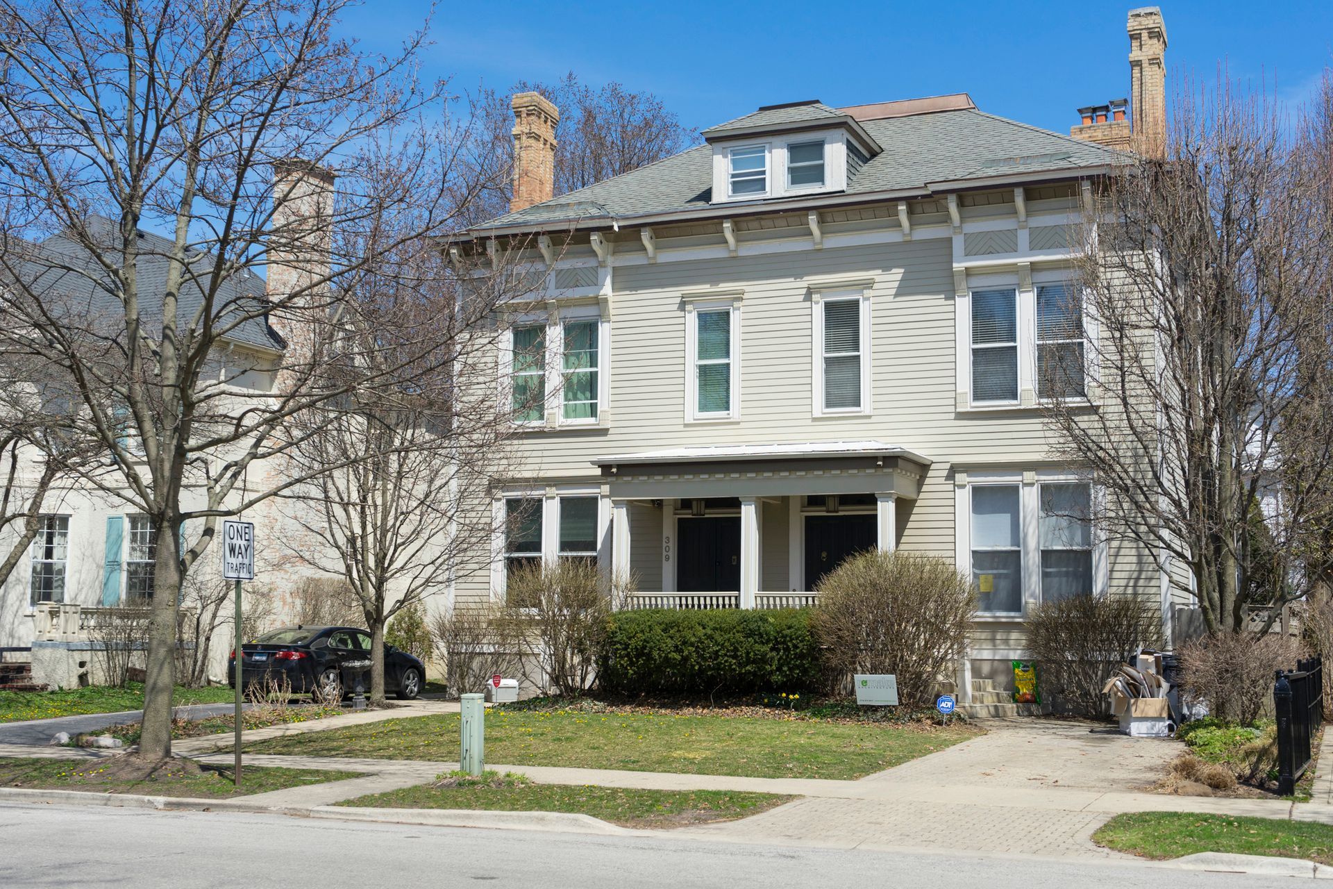 A large brick house with a garage and a driveway