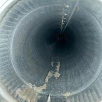 A close up of the inside of a metal pipe.