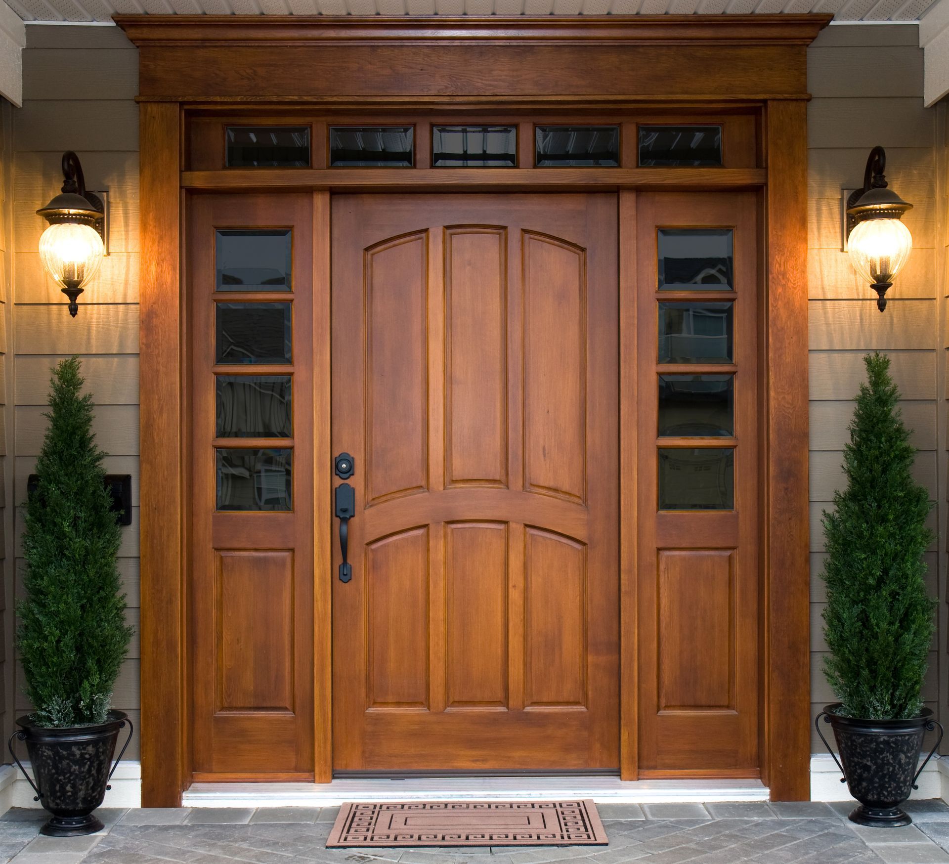 A large wooden door with a stained glass window