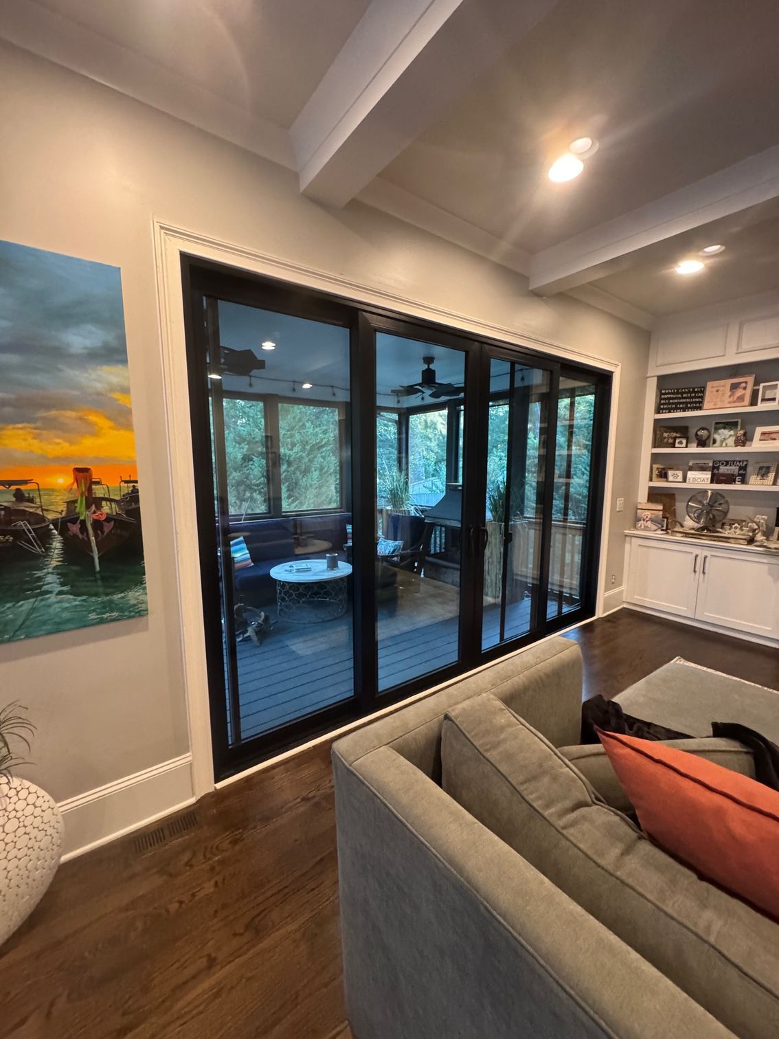 A house with sliding glass doors leading to a patio with a table and chairs.