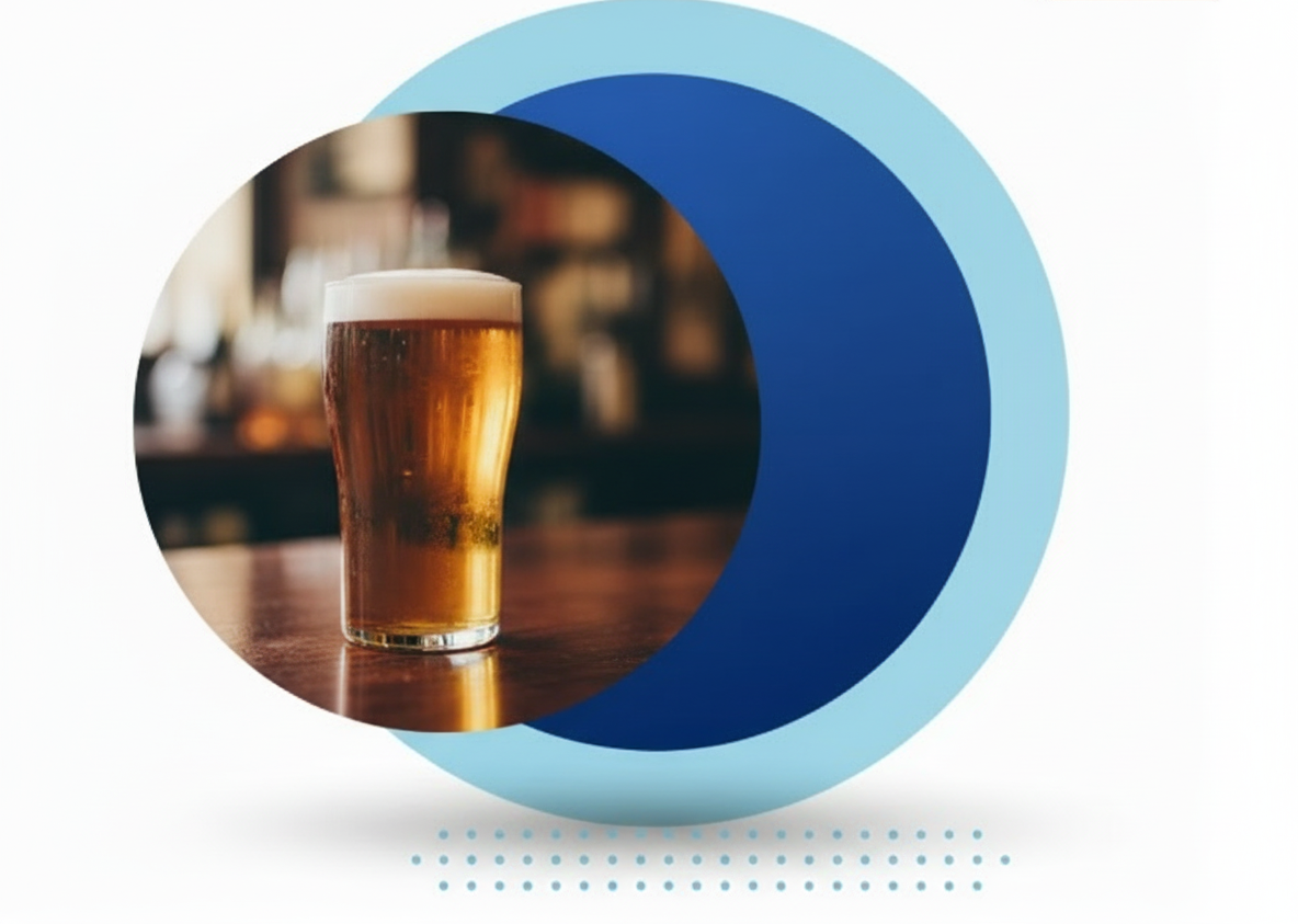 A person sits at a desk working on a laptop, smiling and raising a fist in celebration, with a coffee mug nearby.