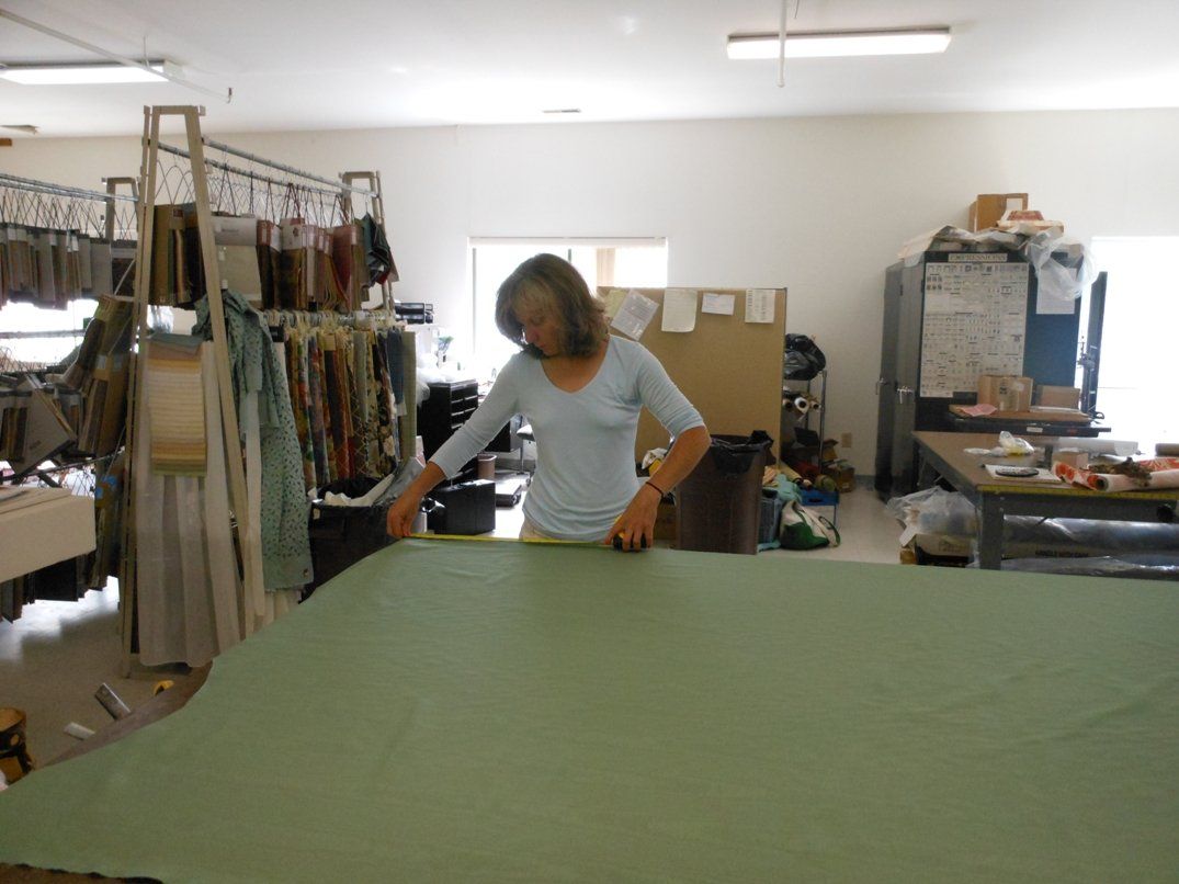 Shop Owners Measuring Green Fabric for Window Treatments