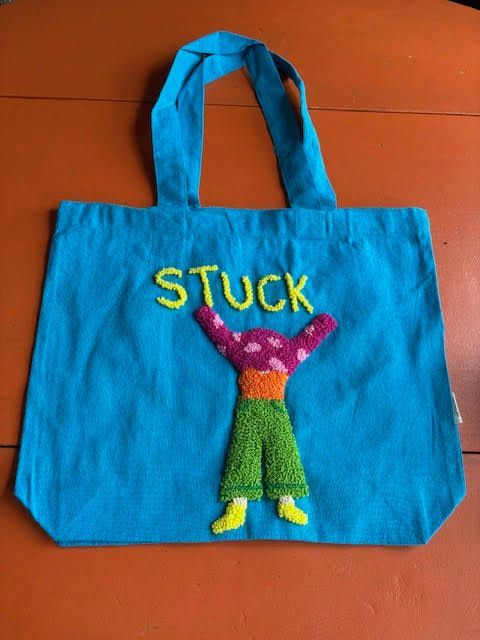 Blauwe draagtas met de tekst 