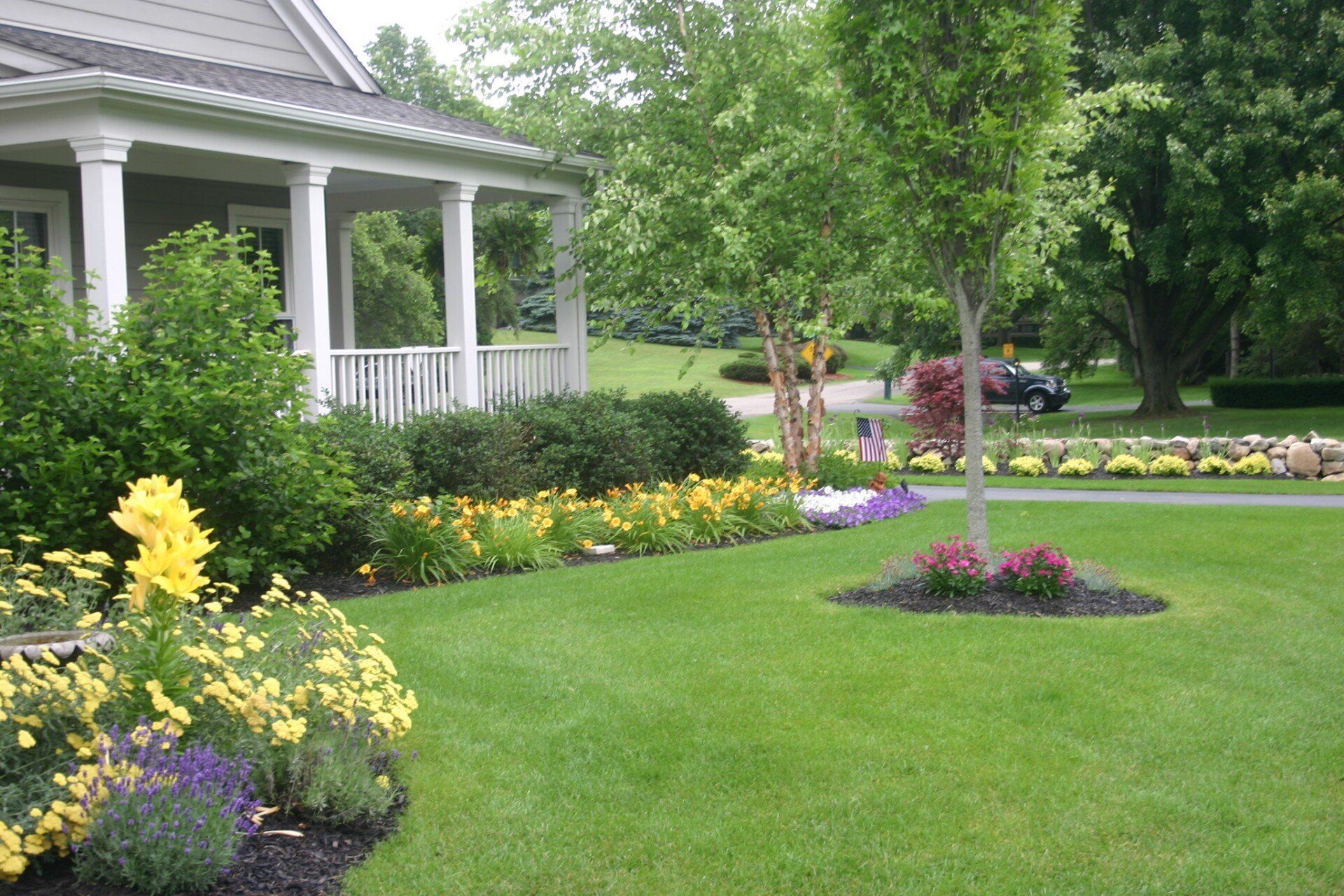 Retaining walls with pink flowers — Clarkston, MI — Lowries Landscape Inc