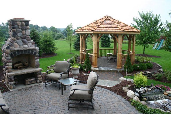 Seats and fireplace in front of gazebo — Clarkston, MI — Lowries Landscape Inc