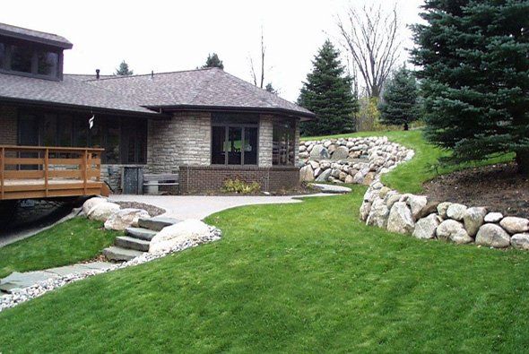 Stone wall around house — Clarkston, MI — Lowries Landscape Inc