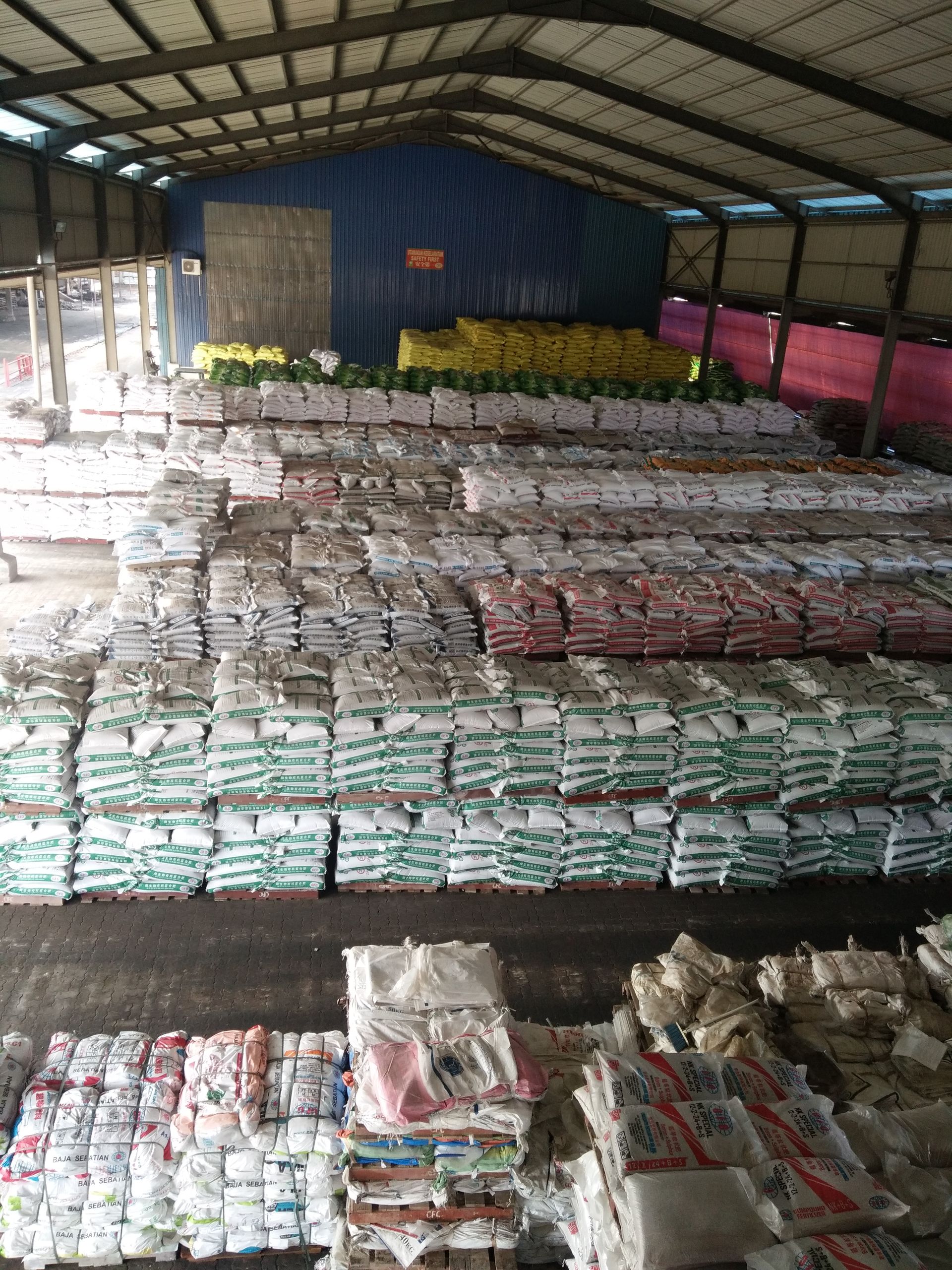 A large warehouse filled with lots of bags of food.