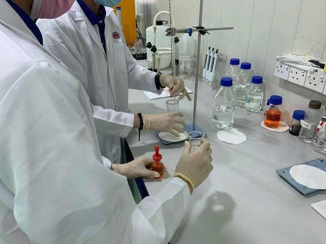 A couple of people are working in a lab.