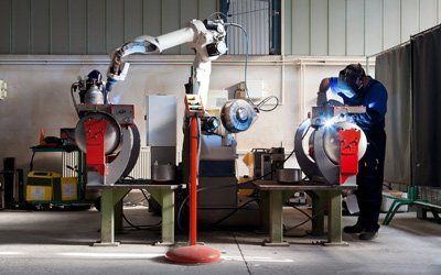 Industrial Jobs — Man and Robotic Machine Working Together in Cullman, AL