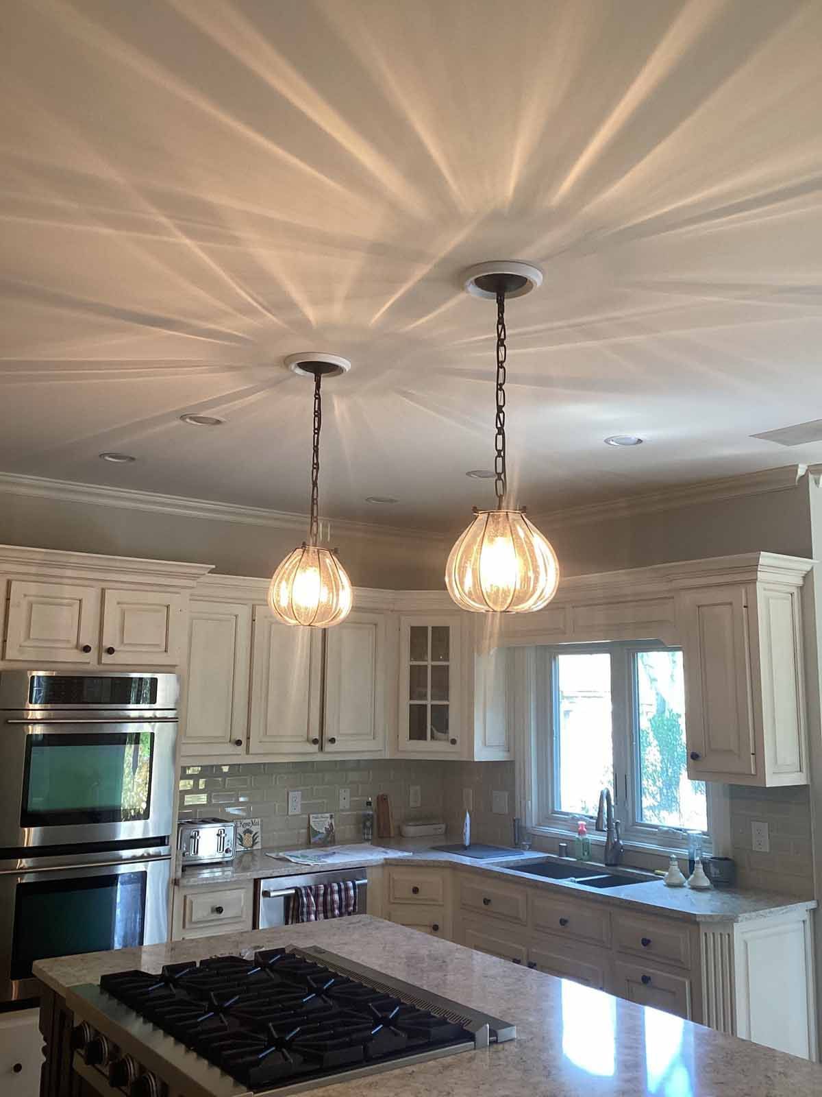 A kitchen with white cabinets and a stove top oven