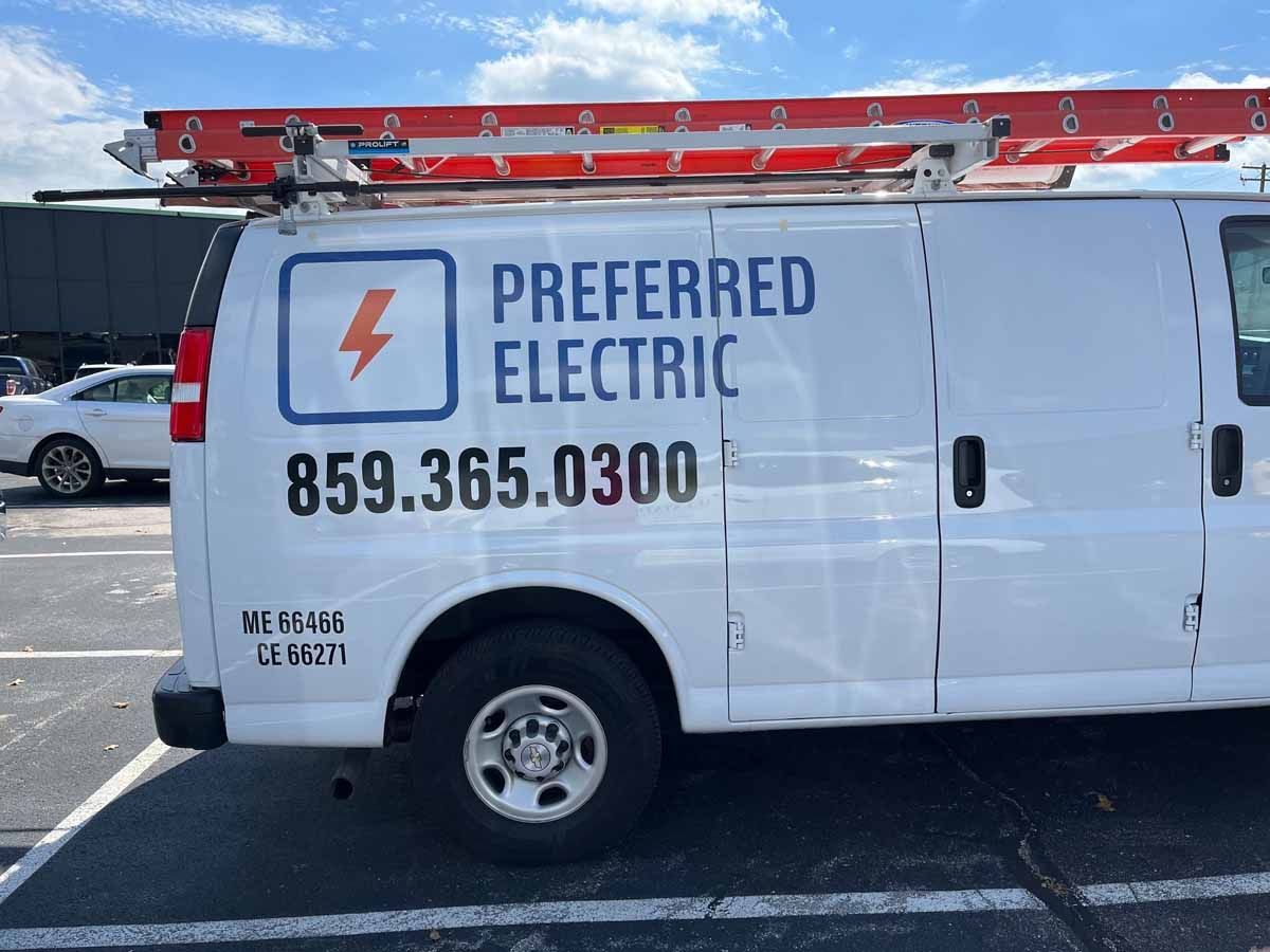 A preferred electric van is parked in a parking lot.