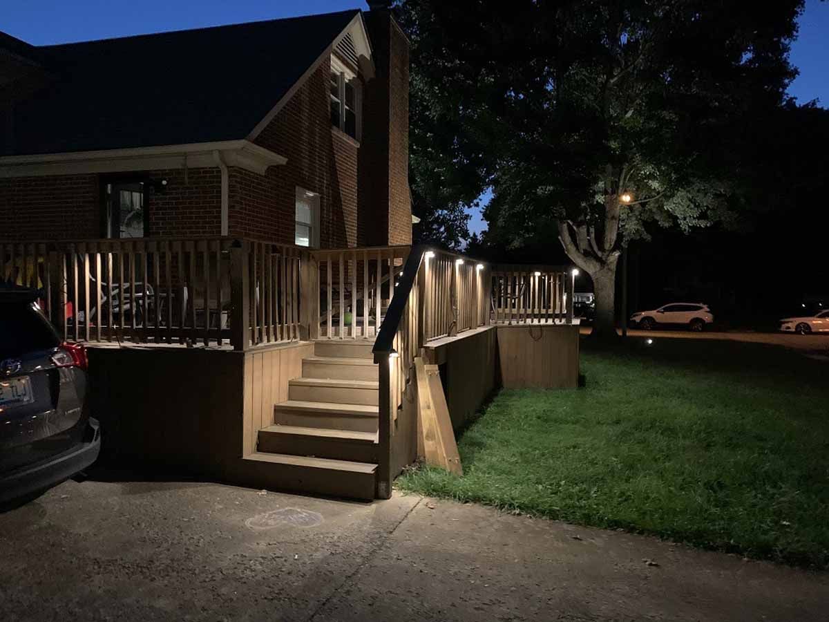 A car is parked in front of a house at night