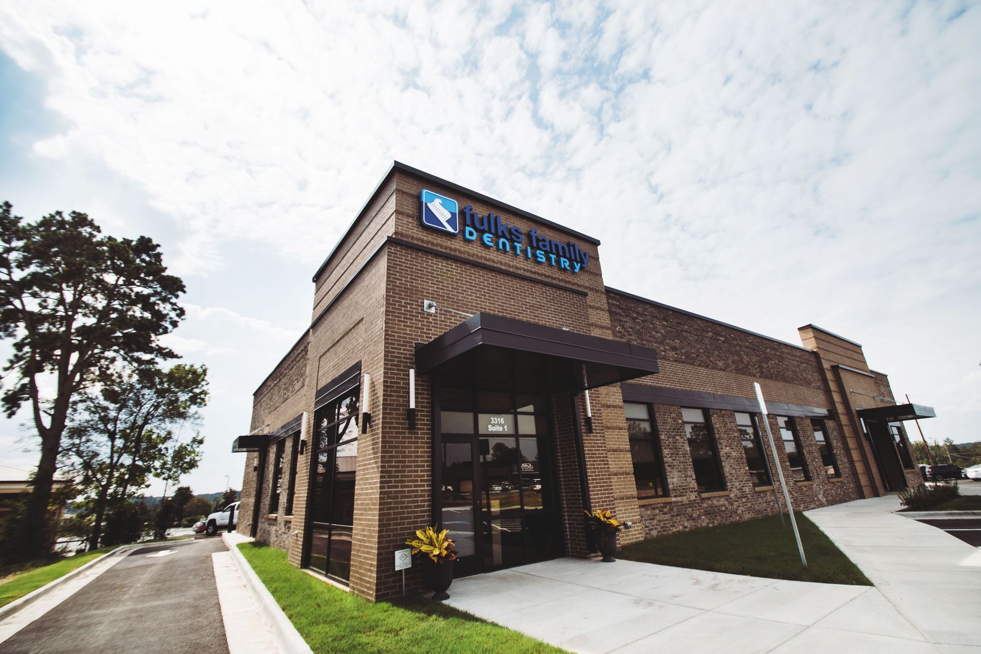 A large brick building with a blue sign on the side of it.