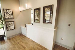 A reception area in a dental office with a counter and mirrors.
