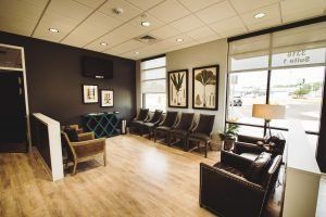 A waiting room with a lot of chairs and a large window.