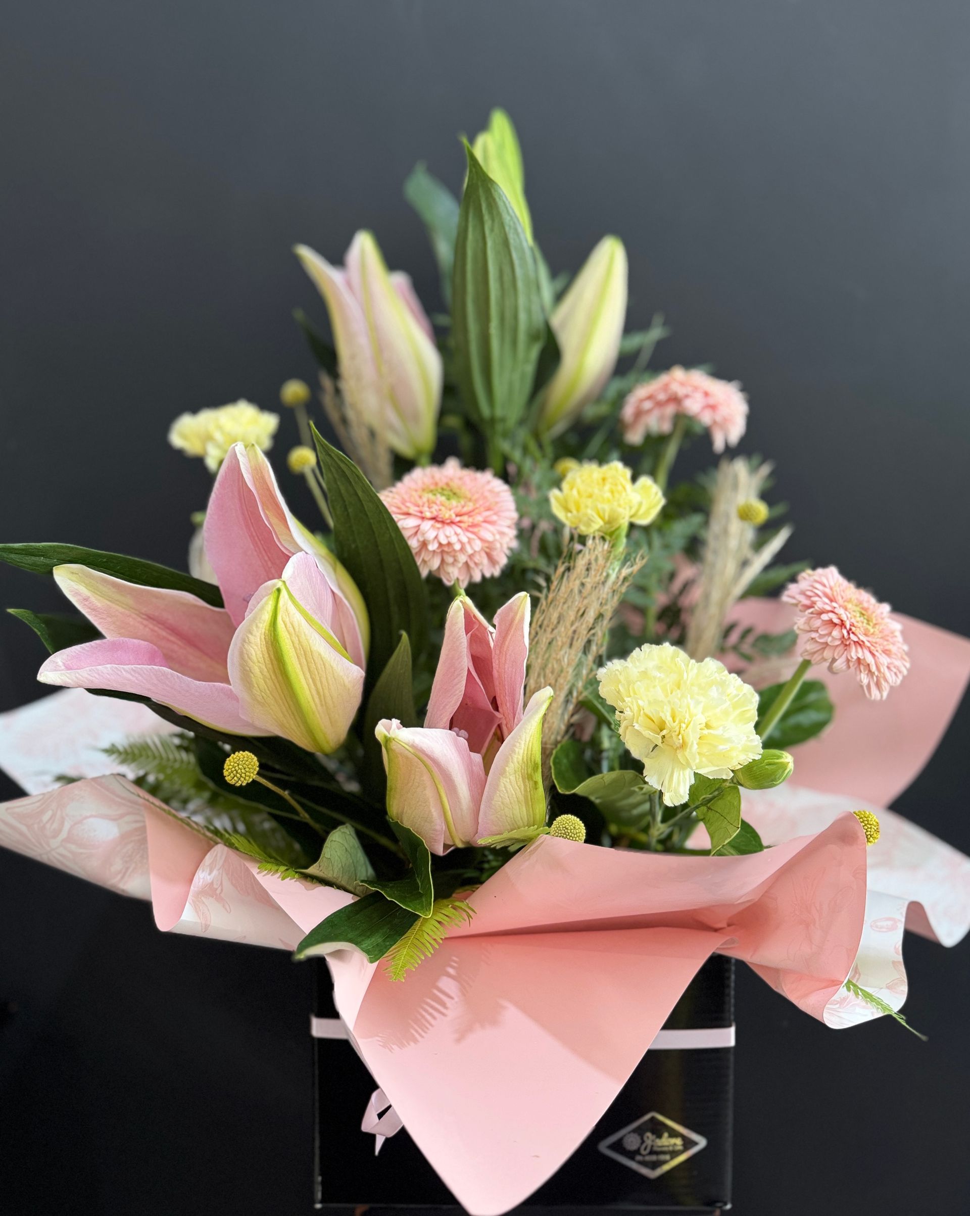 Pink Lilies and Carnations in a Black Box With Pink Tissue Paper — J'adore Flowers & Gifts Cairns In Earlville, QLD