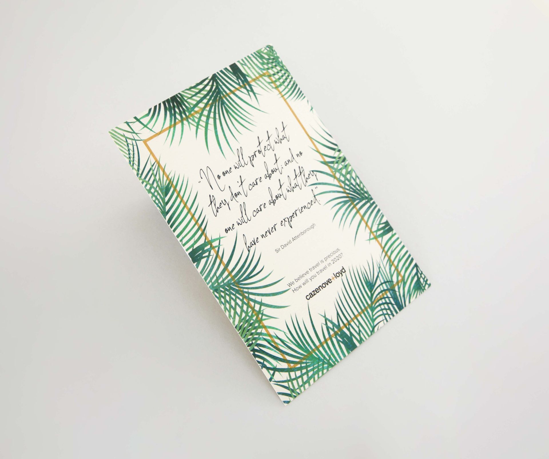 Greeting card with palm leaves design and gold frame with text.