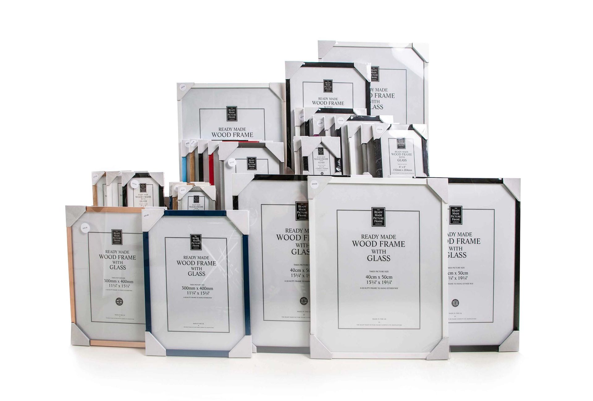 Various sizes of picture frames, mostly white with black and blue accents, stacked on white background.