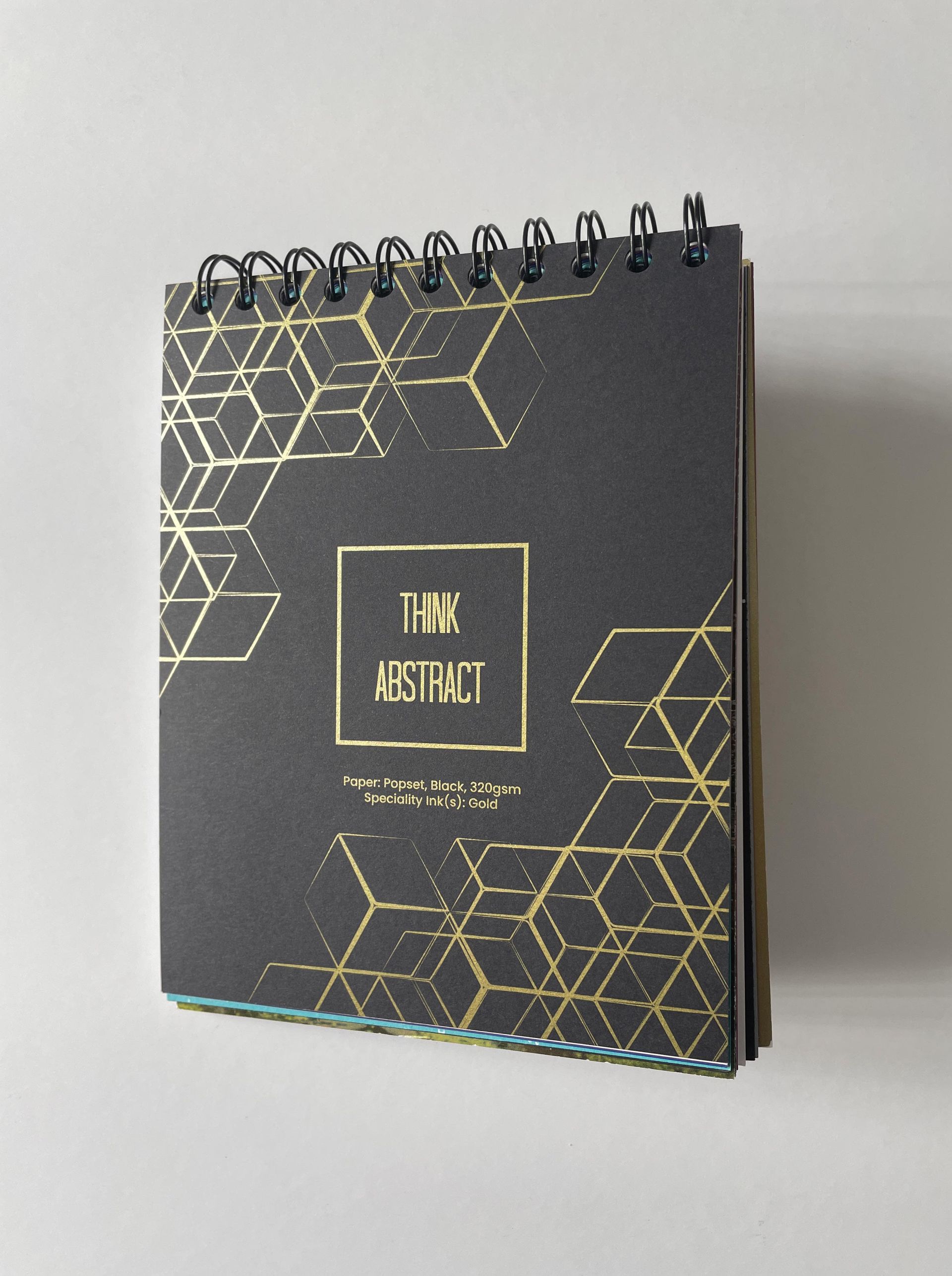 Black notebook with gold geometric design and