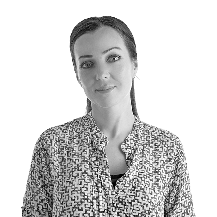 A black and white photo of a woman wearing a patterned shirt
