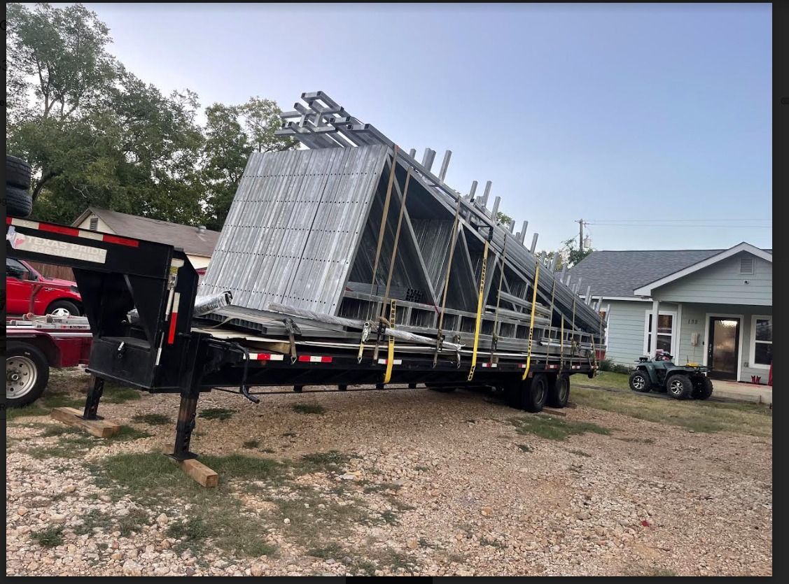Trailer loaded with metal scaffolding.