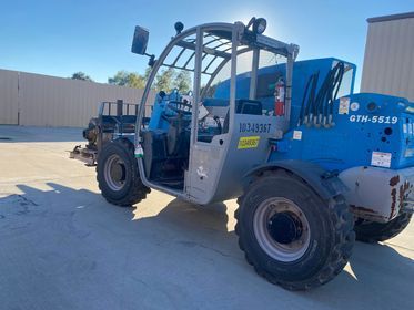 Blue Genie telehandler parked on a sunny day.