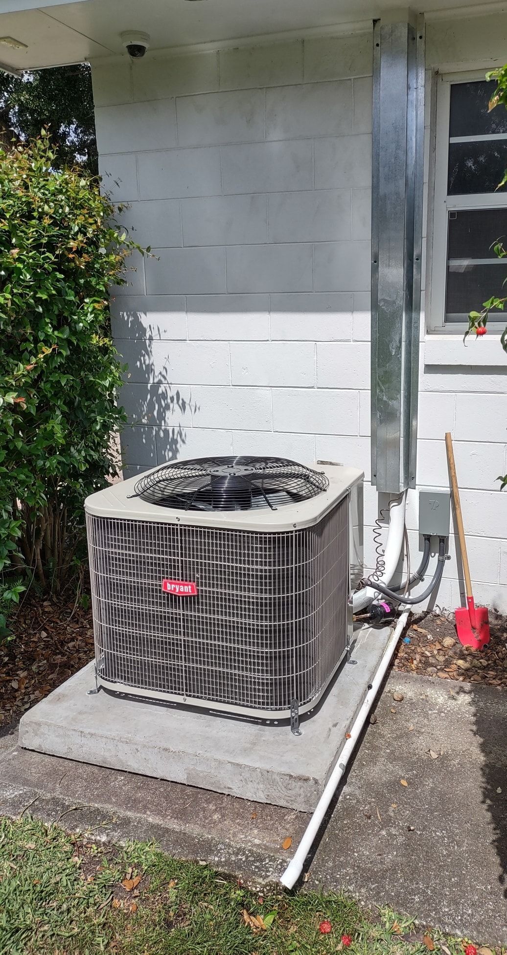 an air conditioner is sitting on the side of a house .