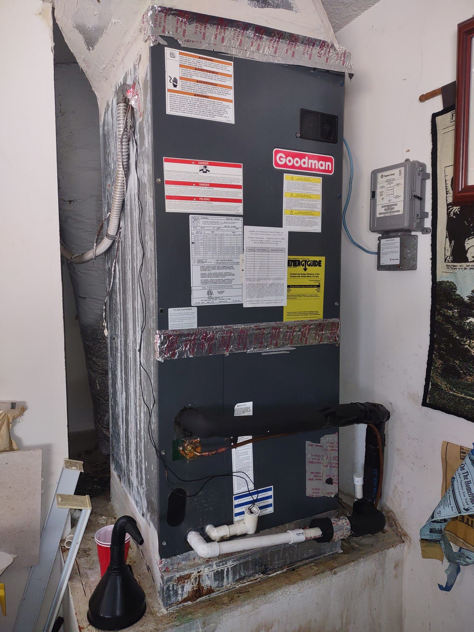 a heater is sitting in a corner of a room next to a wall .
