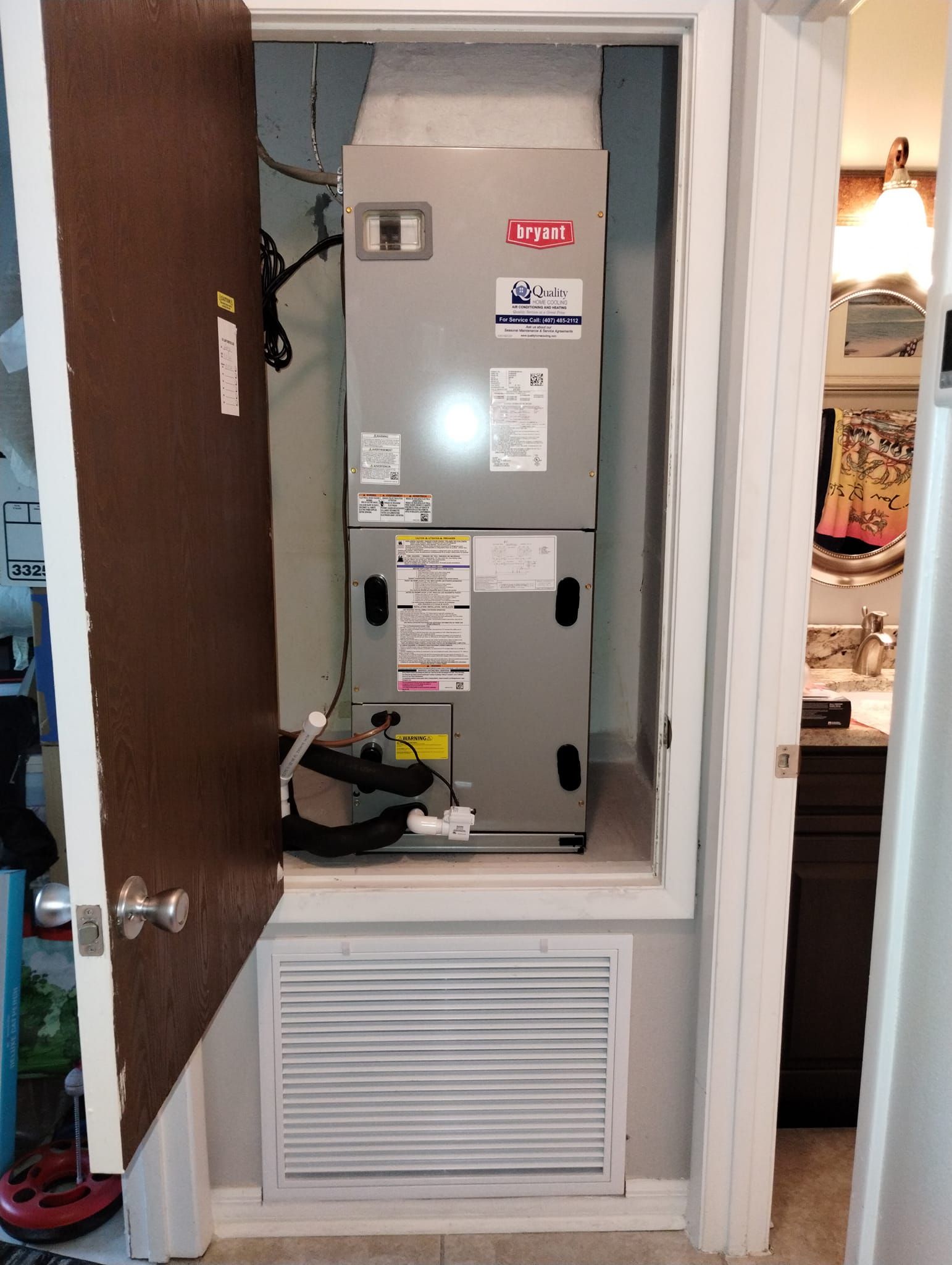 an air conditioner is sitting inside of a closet next to a door .